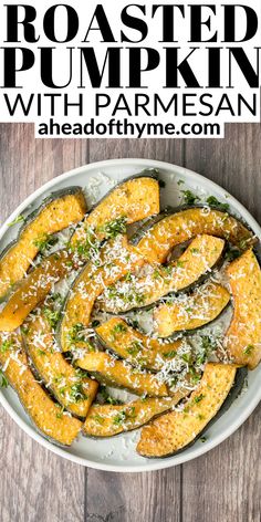 roasted pumpkin wedges with parmesan cheese and herbs on a white platter