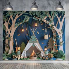 a room with a teepee tent and trees on the wall, lit by candles