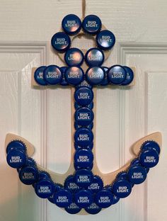 an anchor made out of blue bottle caps