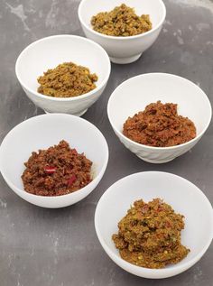 five bowls filled with different kinds of food