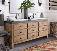 a bathroom with two sinks and mirrors on the wall