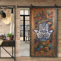 an open door with a hamsa hand painted on it and hanging from the side