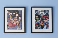 two framed comics are hanging on the wall next to each other, with one being an action hero