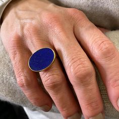 An ancient color combination in blue and gold, this Gabriella Kiss ring features an east-west bezel set oval lapis slab, with a buttery smooth surface to the deep blue stone. Lapis measures 3/4” x 5/8”. Size 5.75. Handcrafted in Hudson Valley, NY, U.S. 12mm Offset Stone Ring, Heirloom Gemstone Signet Ring, Handmade Stone Setting Ring, Unisex Sapphire Ring, Luxury Artisan Rings With Bezel Setting, Luxury Sapphire Signet Ring In Fine Jewelry Style, Luxury Handmade Oval Sapphire Ring, Luxury Modernist Gemstone Signet Ring, Contemporary Artisan Ring