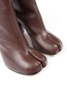 These chic ankle boots are perfect for stepping out in style and comfort. They have a fun, unique design that'll make you feel like you're walking on clouds. Trust me, your feet will thank you. Color: Bordeaux Season: FW24 Made in: Italy Signature Tabi toe with hook fastening 80mm stacked heel Crafted from calf leather and lambskin Leather outsole Tabi Boots, Maison Margiela Tabi, Margiela Tabi, Leather Cap, Brown Ankle Boots, Brown Leather Boots, Leather Jewelry, Stacked Heel, Leather Ankle Boots