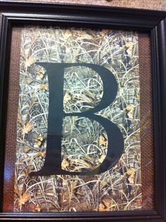 the letter b is made out of hay and wood with black paint on it's frame