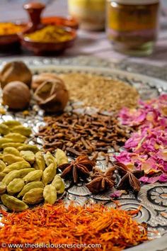 an assortment of spices and herbs on a plate