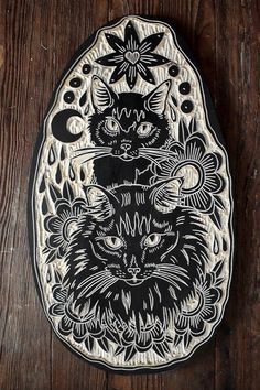 a black and white plate with a cat on it's face in front of a wooden background