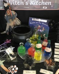 witch's kitchen on display at an outdoor halloween event with witches and other items