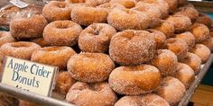 an assortment of apple cider donuts on display