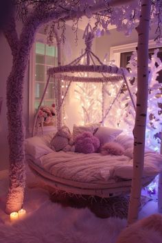 a white bed sitting under a tree next to a window