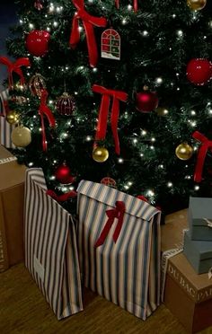 presents under the christmas tree are wrapped in striped paper