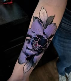 a person with a flower tattoo on their arm