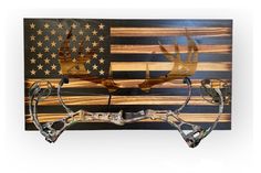 an american flag and deer antlers are mounted to the side of a wooden wall