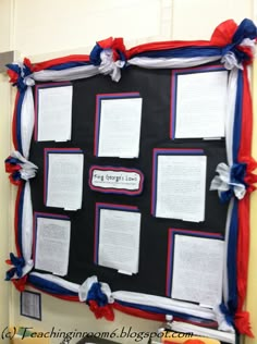 the bulletin board is decorated with red, white and blue ribbons on it's sides