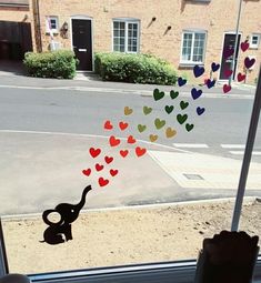 the window is decorated with hearts and an elephant