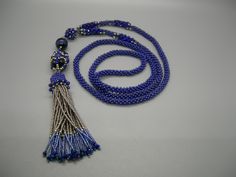 Handmade beautiful one of a kind beaded necklace embellished with 3mm Lapis Lazuli and crystals. Hand beaded tassel decorated with 3mm Lapis Lazuli beads. Perfect for casual or formal occasion. Elegant Beaded Necklaces For Meditation, Elegant Beaded Necklace For Meditation, Blue Beaded Tassel Long Necklace, Blue Beaded Long Tassel Necklace, Elegant Handmade Tassel Necklace With Round Beads, Elegant Blue Tassel Necklace As Gift, Elegant Blue Tassel Necklace Gift, Blue Beaded Lariat Necklace With Round Beads, Long Beaded Necklace With Tassels As Gift