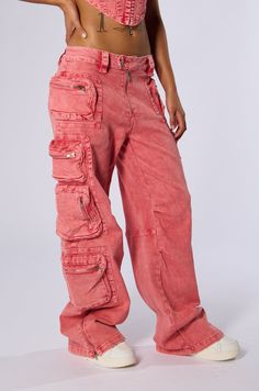 Born to be a princess in The AKIRA Label Out The Mud Acid Wash Cargo Pant. This funky piece is crafted from a slightly stretchy cotton fabrication and features an acid wash patterning, a high rise design, functional wide belt loops, tonal stitching, faux silver metallic hardware, four horizontal and vertical zippered pouch pockets on each leg, and a zippered detail on each pant leg for an optional slit. Complete with a front button zip closure, functional back zipper pockets, and a wide leg silhouette. Pair with the coordinating AKIRA Label Out The Mud Acid Wash Denim Corset Top for a pretty in pink moment. - 98% Cotton 2% Spandex- Slight Stretch- Imported (all measurements approximate from size small) - 10” Rise- 31.2” Inseam- Model is 5’7”Product ID: 397665 (all measurements approximate Denim Corset Top, Denim Corset, Acid Wash Denim, Zippered Pouch, Cargo Pant, Wide Belt, Acid Wash, Corset Top, Pocket Pouch