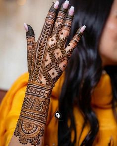 a woman's hand with henna on it