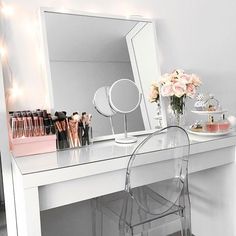 a white desk topped with a mirror and lots of makeup on it's side