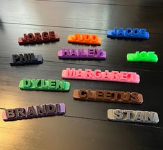 colorful plastic name tags sitting on top of a wooden table