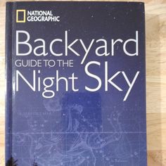 a book with the title backyard guide to the night sky written in white on it