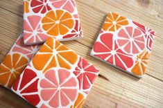 four orange slices are sitting on top of each other in the shape of coasters