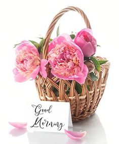 pink flowers in a basket with a note saying good morning