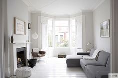 a living room filled with furniture and a fire place