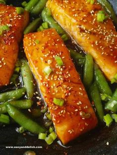 salmon and green beans in a skillet with sesame seeds