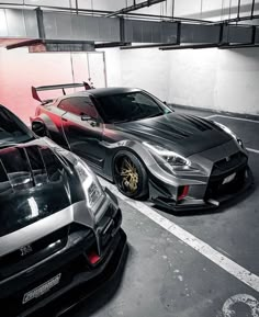 two cars parked in a parking garage next to each other