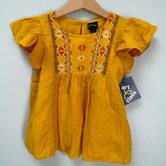 Nwt Lovely Babydoll Top, Linen Look. Flowy With Ruffled Cap Sleeves. True Color Is Rich Egg Yolk Yellow: Leans Mustard In Some Light And Sunflower Yellow In Others. Embroidery In Pattern Of Geometric Angles And Flowers In Red, Black, White, And Ochre. Never Worn, Washed. Stored Well. Smoke Free, One Non-Shedding Dog Home. Same/Next Day Shipping. Bundle Offers Welcomed. Yellow Spring Tops For Playwear, Yellow Tops For Spring Playwear, Embroidered Summer Tops For Playtime, Embroidered Cotton Top For Playtime, Cute Yellow Fitted Blouse, Fitted Yellow Tops For Playtime, Embroidered Cotton Blouse With Flutter Sleeves, Summer Flutter Sleeve Tops For Playtime, Cotton Flutter Sleeve Tops For Playtime