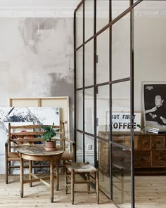 a living room filled with furniture next to a wall covered in peeling paint on the walls