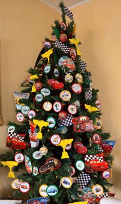 a decorated christmas tree with cars on it