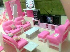 a doll house living room with pink furniture