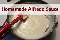 a red spatula is being used to make homemade alfredo sauce in a pan on the stove