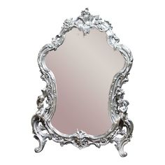 an ornate silver mirror on a white background