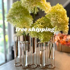 three vases filled with flowers on top of a table