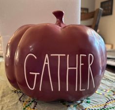 a ceramic pumpkin with the word gather written on it