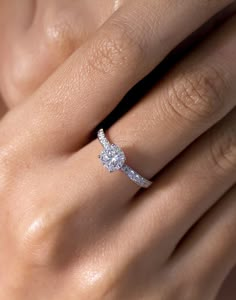 a woman's hand with a diamond ring on it