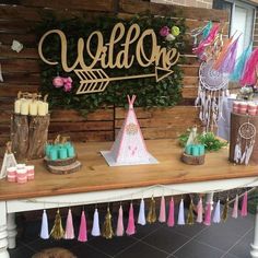 a wooden table topped with lots of decorations and decorating on it's sides