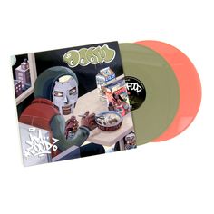 an orange and green colored vinyl record with a cartoon character eating food on the table