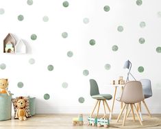 a child's room with green polka dot wall decals and toys on the floor