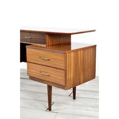 a wooden desk with two drawers on one side and an open drawer on the other