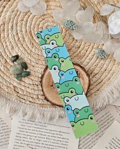 a bookmark with elephants on it sitting on top of a table next to an open book