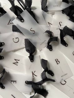 black and white ribbons are scattered on top of each other with letters cut into them