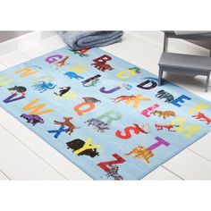 a child's rug with letters and animals on it