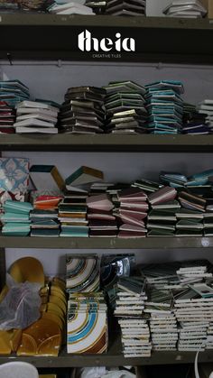 there are many plates and bowls on the shelves