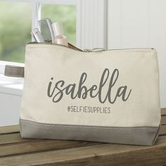 a personalized makeup bag sitting on top of a wooden table