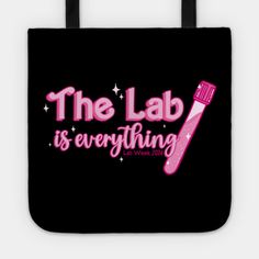 the lab is everything tote bag with pink writing on it and stars in the background